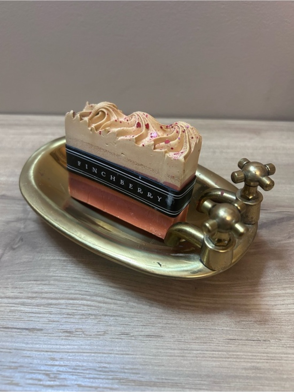 Vintage brass soap dish in the shape of a bathtub
